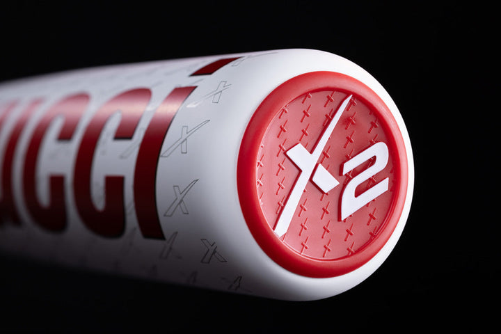 A close-up of a white and red cylinder featuring the 2025 Marucci CATX2 Connect (-5) 2 3/4" USSSA Baseball Bat (MSBCCX25 DEMO) with two-piece hybrid construction and anti-vibration technology.