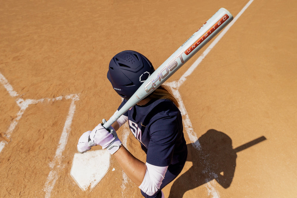 A person holding the 2025 Easton Ghost Unlimited (-11) Fastpitch Softball Bat, model EFP5GHUL11 (DEMO) by Easton.