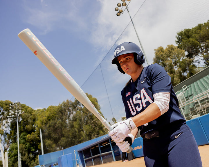 A woman holding the 2025 Easton Ghost Unlimited (-9) Fastpitch Softball Bat (EFP5GHUL9) by Easton.
