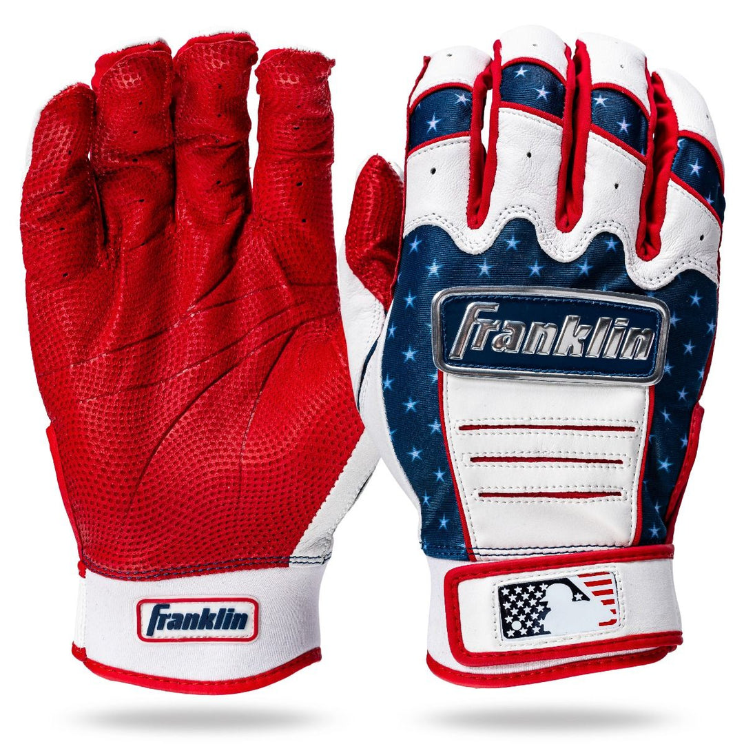 Franklin CFX Pro Fourth of July Limited Edition Batting Gloves: one solid red, the other features American flag stars and stripes. Both display Franklin and MLB logos at the wrist.