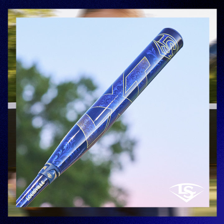 The 2025 Louisville Slugger LXT (-11) Fastpitch Softball Bat (WBL2993010) is shown outdoors with a blurred backdrop of trees and sky, displaying its striking blue and gold design and bold Louisville Slugger branding.