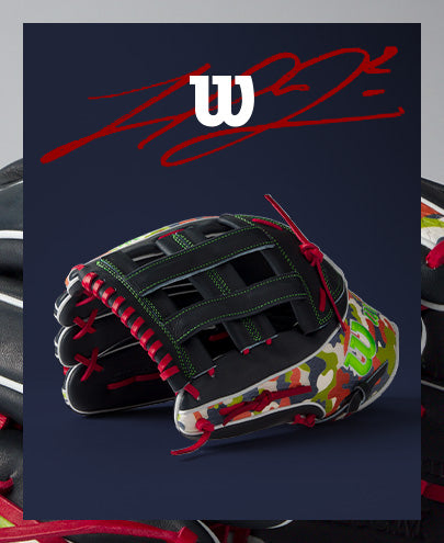 A Wilson A2K MH23 12.75" Michael Harris GM Baseball Glove in black and camo with red lacing, crafted from Pro Stock Select leather, rests on a dark surface with the Wilson logo above and a red signature-style graphic in the background.