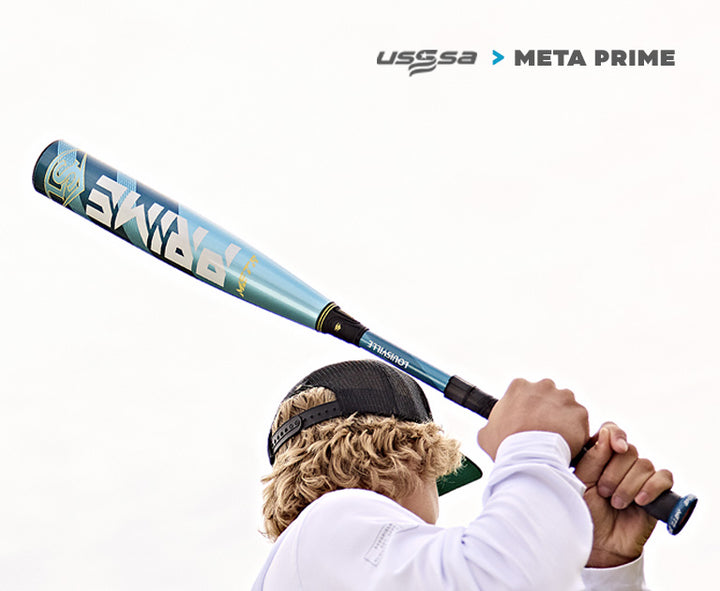 A blond, curly-haired baseball player with a backwards cap grips the 2025 Louisville Slugger Meta Prime (-8) 2 3/4" USSSA Baseball Bat (WBL2971010), preparing to swing as USSSA and Meta Prime logos appear in the top right.