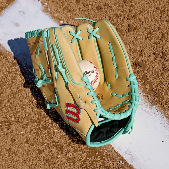 A Wilson A2000 B12 12" Baseball Glove (WBW10349812) rests on a white line, its Pro Stock leather highlighting the expert craftsmanship of this Wilson classic.