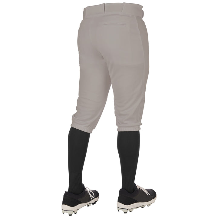 A person wearing Champro Sports Adult Triple Crown 2.0 Knicker Baseball Pants (BP68) in light gray, paired with black knee-high socks and cleats, is shown from the back against a plain white background.