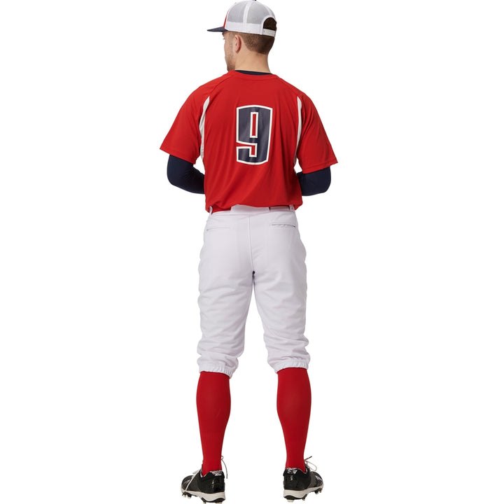 A baseball player stands facing away in a red jersey with the number 9, red socks, black cleats, a white and red cap, and Champro Sports Adult Triple Crown 2.0 Knicker Baseball Pants (BP68).
