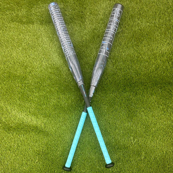 A pair of composite bats, including the Pure Sports 2025 Storm Shadow 13″ Balanced USA Slowpitch Softball Bat (5147M91B), rests on the grass.