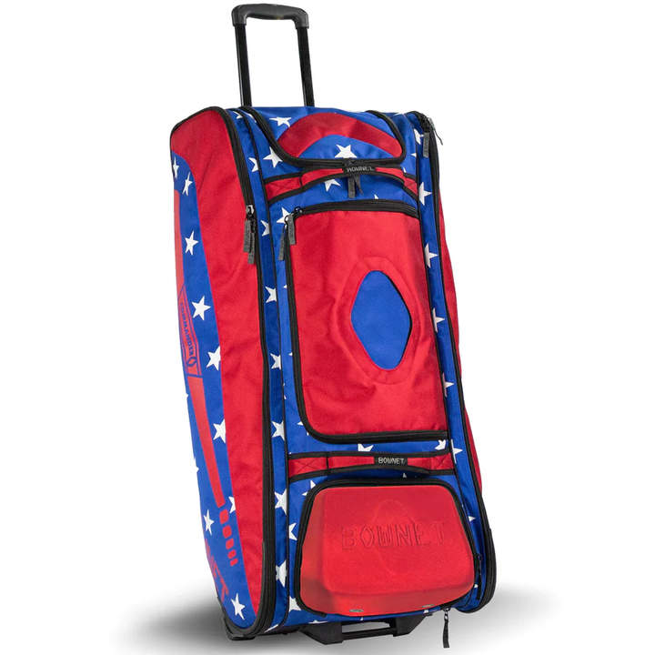 The Bownet Commander Wheeled Catcher's Bag (BN-COMMANDER BAG) features a telescopic handle, multiple zippered pockets, and star-themed red and blue designâperfect for storing all your baseball gear.