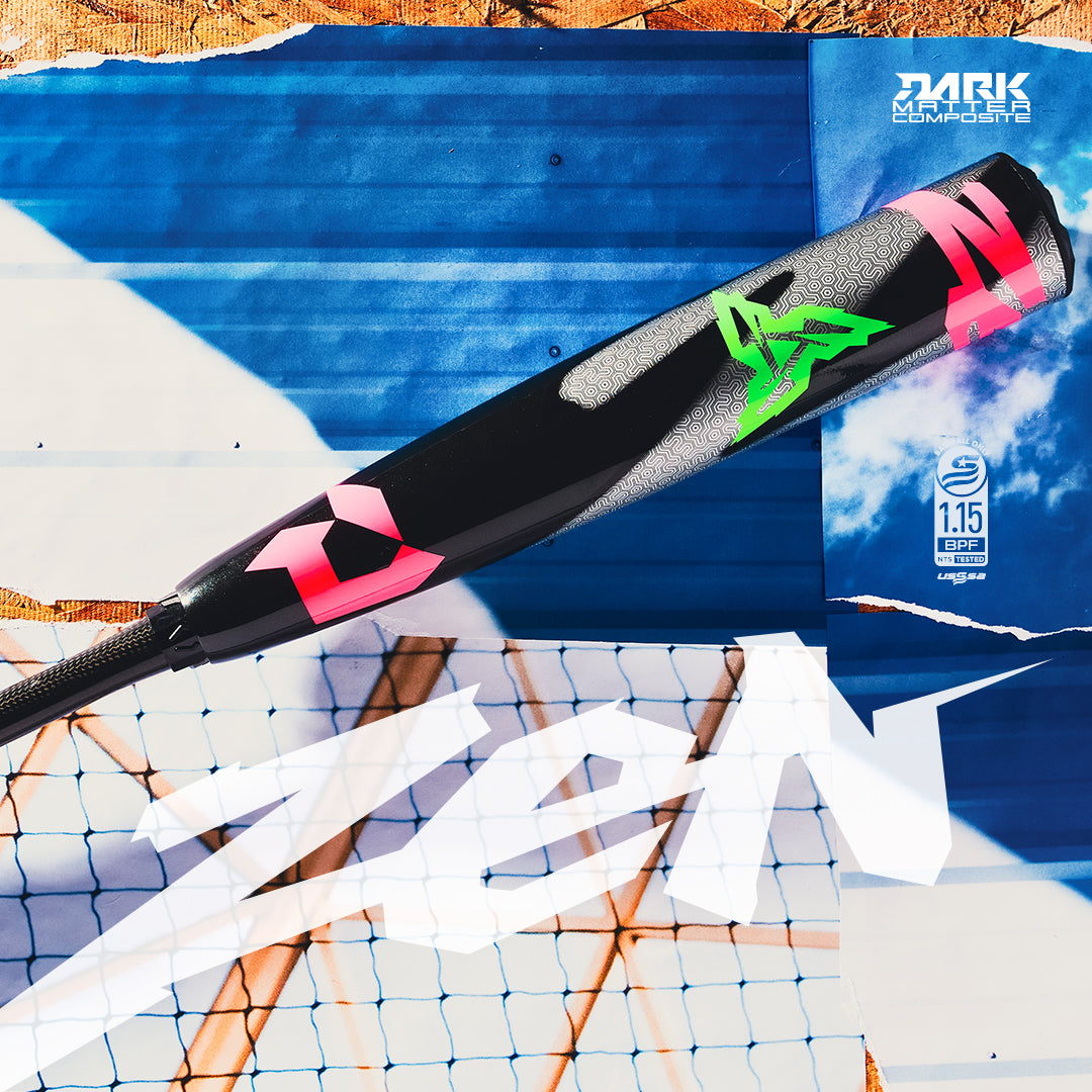 A close-up of a black and pink baseball bat with green accents, lying on a blue and white background with grid patterns and the word ZEN in bold white letters. The bat displays certification and brand markings.