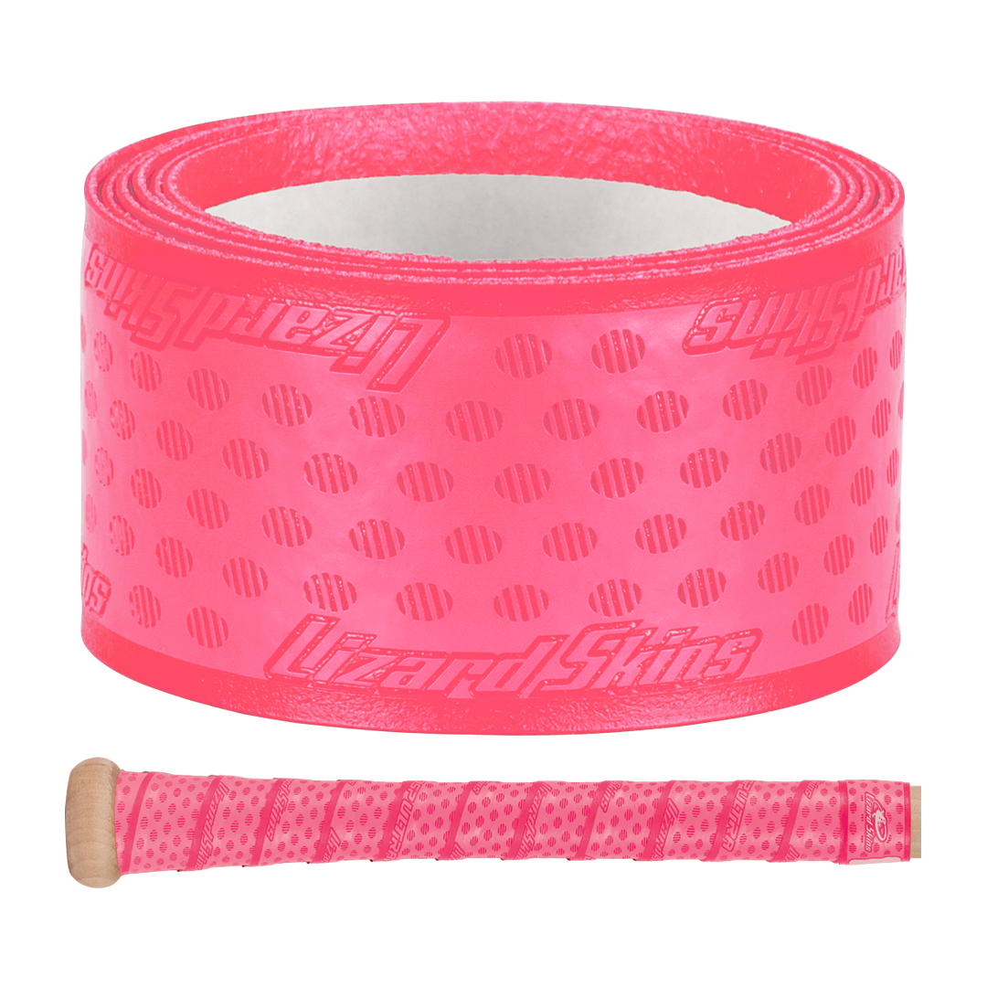 A roll of Lizard Skins DSP Ultra Solid 1.1mm Bat Grip in bright pink, featuring textured dots and diagonal lines, is displayed above a wooden handle wrapped in the same vibrant grip from Lizard Skins.