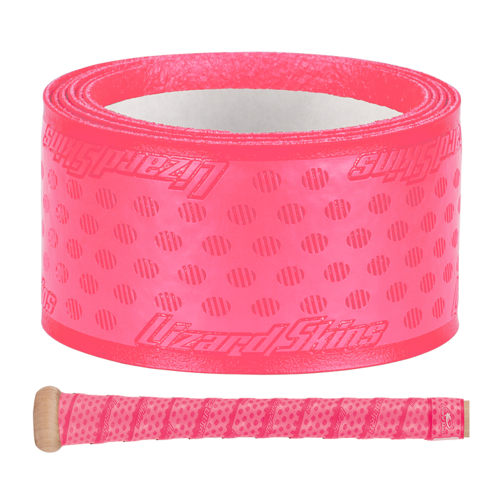 A roll of Lizard Skins DSP Ultra Solid 1.1mm Bat Grip in bright pink, featuring textured dots and diagonal lines, is displayed above a wooden handle wrapped in the same vibrant grip from Lizard Skins.