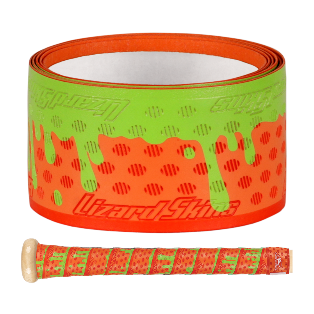 The Lizard Skins DSP Ultra Outburst 1.1mm Bat Grip in Orange Slime features a dripping paint and dot design, shown both rolled up and on a bat handle, highlighting the durable polymer trusted by Major League Baseball players.