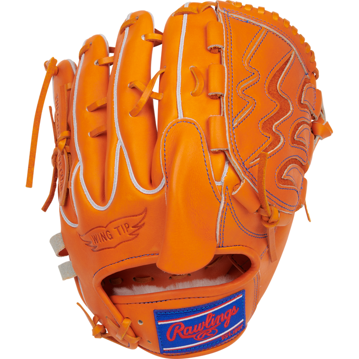 An orange Rawlings Heart of the Hide 11.75" Japan Series Baseball Glove (GH3FHPA15W) features white stitching, wing tip design, a blue/red Rawlings patch by the wrist, and premium U.S. Steerhide leather. Palm down on a white background.