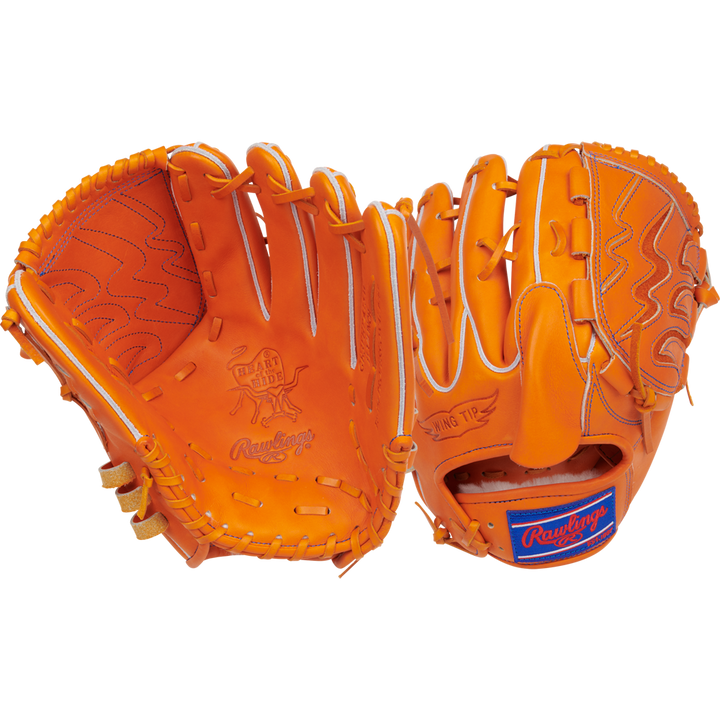 Two bright orange Rawlings Heart of the Hide 11.75" Japan Series gloves are shown—one displaying the stitched palm and logo, the other showing the back with patch and lacing. Both are crafted from premium U.S. Steerhide leather.