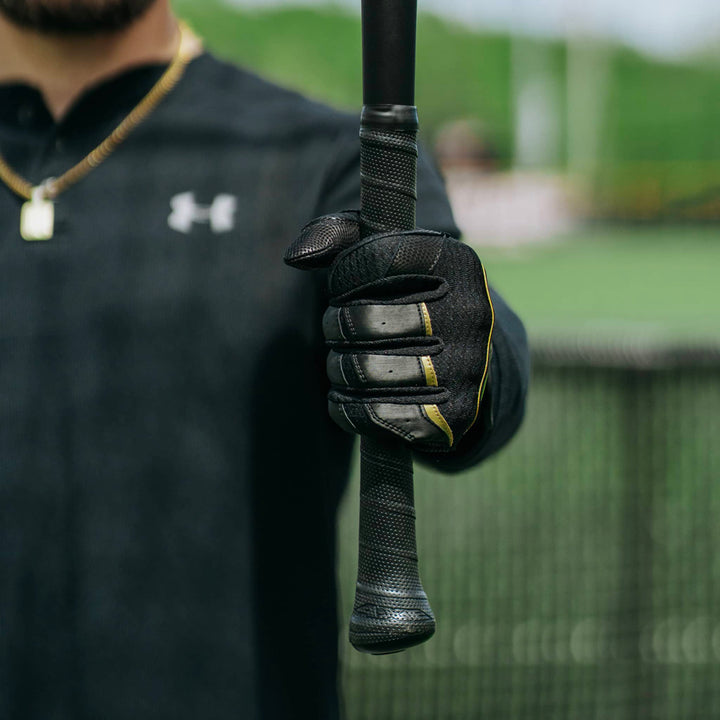 A person holding an AXE Flared Pro Series Maple Wood Baseball Bat (L124K-FLR) with a flared handle.