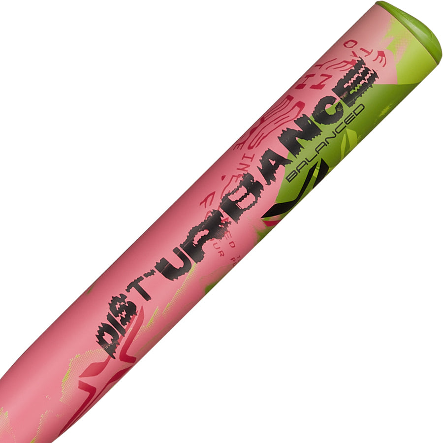 A close-up of the AXE 2025 Disturbance 13" Balanced USA Slowpitch Softball Bat (L155P-FLR), featuring abstract pink and green designs, BALANCED and DISTURBANCE text in black on its composite barrel.