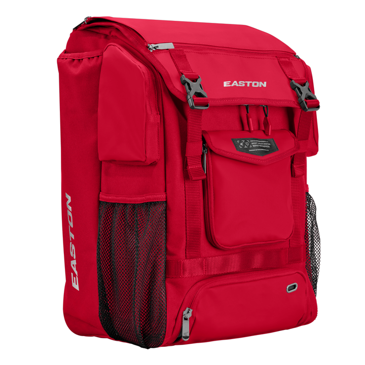 The Easton MAV1 Backpack (MAV1BP) is a high-capacity red gear bag with multiple zippered compartments, mesh side pockets, and adjustable straps, perfect for carrying athletic equipment.