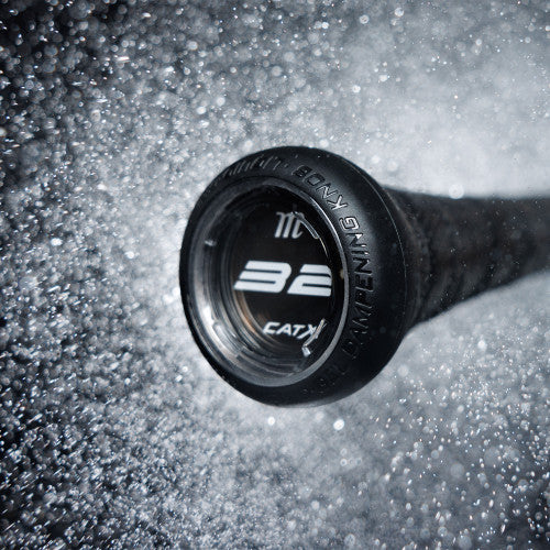 Close-up of the end cap of a black baseball bat labeled 32, surrounded by water droplets or mist, creating a dynamic and energetic effect.