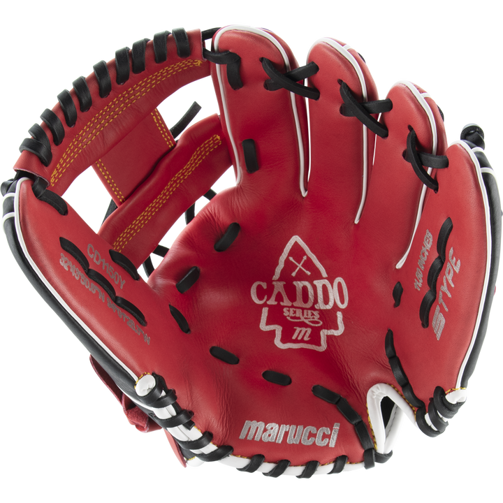 The Marucci Caddo 11.5" Baseball Glove (MFG2CD1150) features red leather with black and white accents, visible stitching, embossed Marucci branding on the palm, an open design showing its interior, finger slots, and adjustable fit.