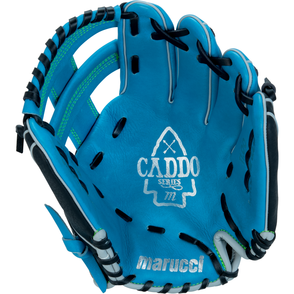 The Marucci Caddo 11" youth baseball glove (MFG3CD110-SB/BK) features blue full-grain cowhide leather, black and white lacing, an arrowhead design, "CADDO SERIES" on the palm, and the Marucci logo at the base.