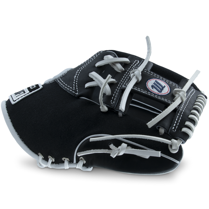 The Marucci NightShift CHUCK T 11.5" Baseball Glove (MFGNTSHFT-0103) features a black and white design with white laces and detailed stitching, displayed on a plain light background.