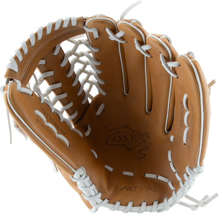 The Marucci Oxbow 79A6FP 13" Fastpitch Glove (MFGOX79A6FP-TF), tan with white lacing and a T-Web, features the Marucci Oxbow logo on the palm and is displayed on a plain white background.