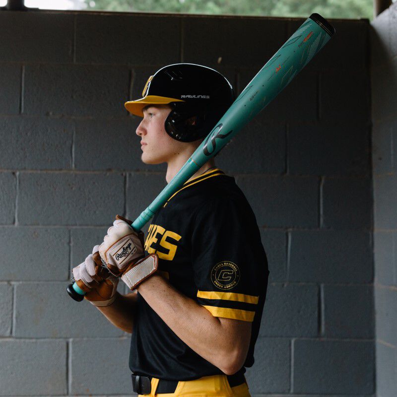 A man holding a used 2024 Rawlings Mach AI (-3) BBCOR Baseball Bat: RBB4MC3.