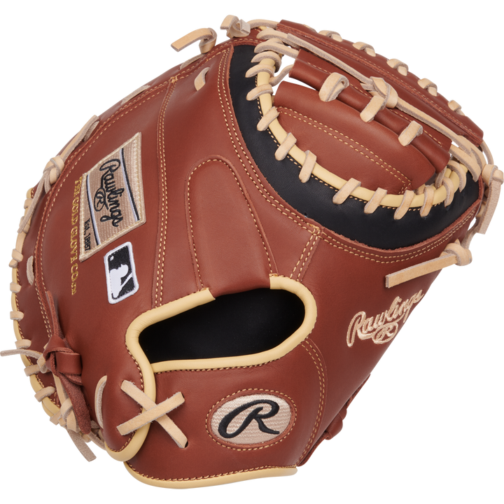 The Rawlings NXT 32.5" Baseball Catcher's Mitt (NXTCM325UDB) features brown leather, tan laces, the Rawlings logo, and a ContoUR fit design, displayed against a white background.