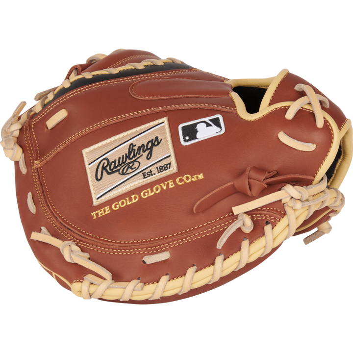 A Rawlings NXT 32.5" brown catcher's mitt (NXTCM325UDB) with ContoUR fit and tan laces, featuring the Rawlings logo, "Est. 1887", "The Gold Glove Co." text, and a small MLB logo patch.