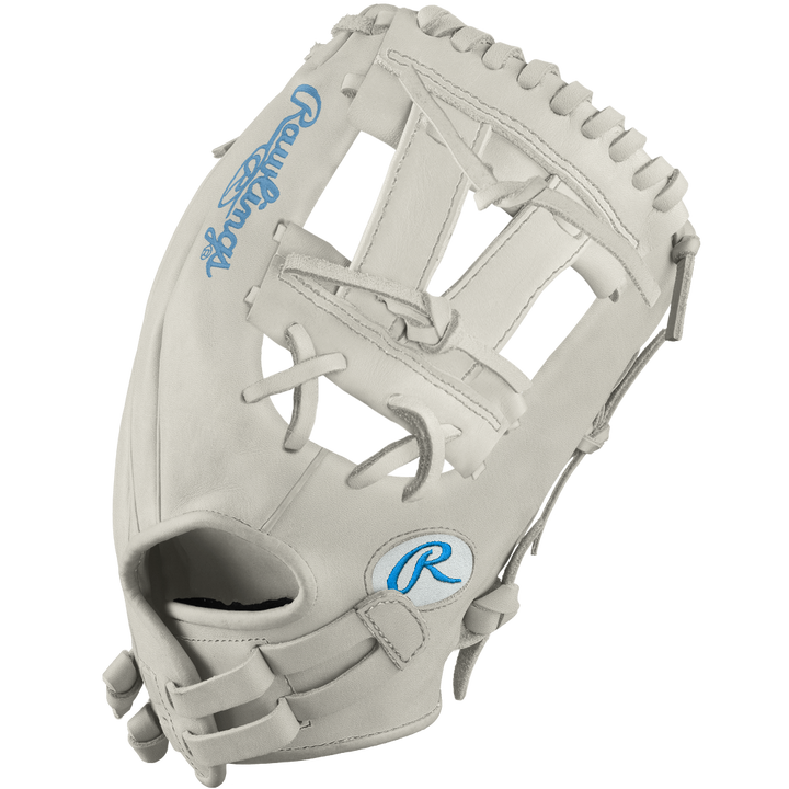 The Rawlings Heart of the Hide 12" Frost DSG Exclusive Fastpitch Glove (PRO120SB-7WCBDSG) in light gray features blue logos, an open web, and leather laces—ideal for softball players seeking top performance and stylish design.