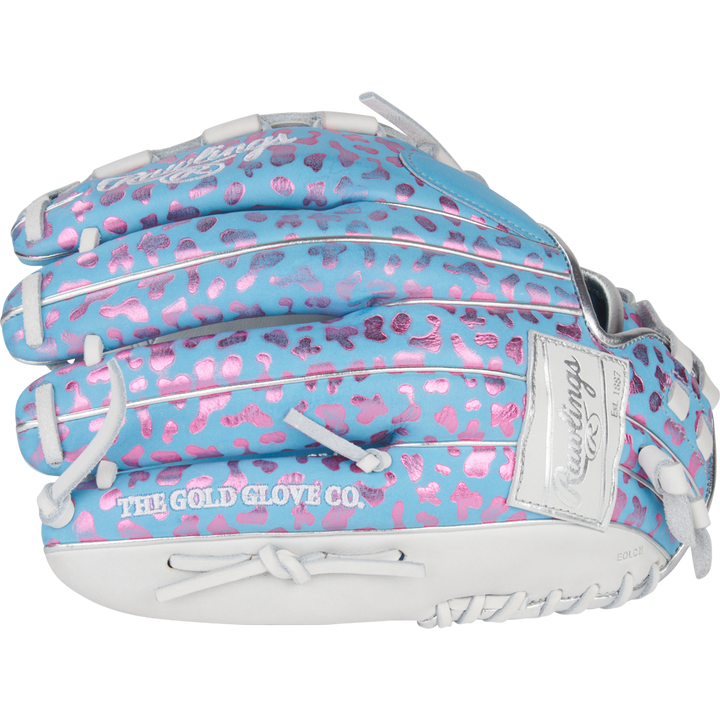 The Rawlings Heart of the Hide 12.5" Fastpitch Glove (PRO125SB-3CBW) features a light blue design with pink leopard spots, white lacing, and "THE GOLD GLOVE CO." stamped in white for a bold and colorful look.