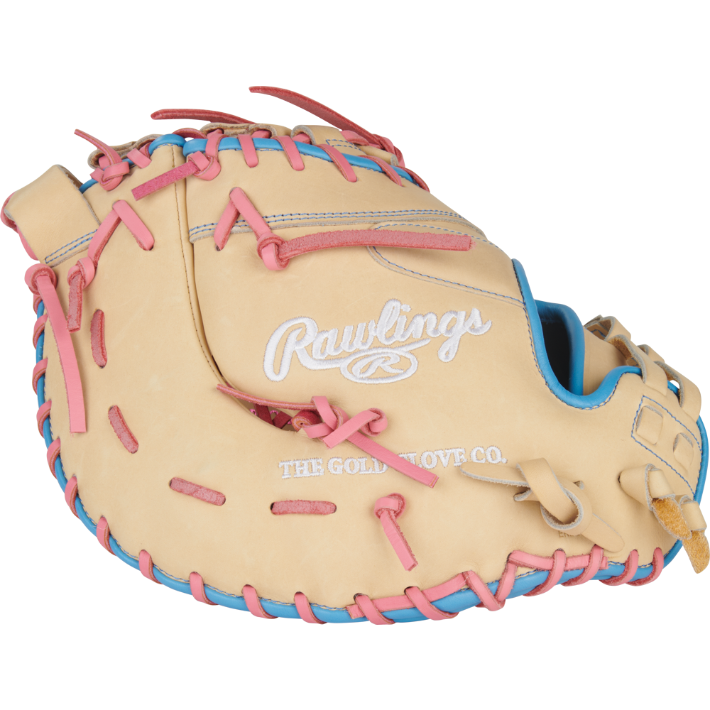The Rawlings Heart of the Hide 13" Fastpitch First Base Mitt (PRODCTSB-10CCB) features a tan design with pink and blue laces, plus embossed white Rawlings and The Gold Glove Co. logos—ideal for first base in fastpitch softball.