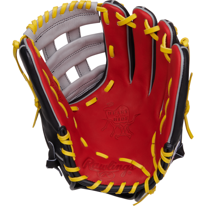 The Rawlings Heart of the Hide 12.25" Baseball Glove (PROKB17SB) features a red, black, and yellow design with yellow laces and white accents, shown palm up against a white background. Inspired by Kris Bryant for pro-level play.