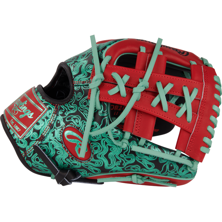 The Rawlings Heart of the Hide 11.5" Color Sync Glove (PROR204W-32BS) features a black base, swirling green patterns, red laces and web, plus light blue and red accents. Rawlings branding appears on the side of this bold glove design.