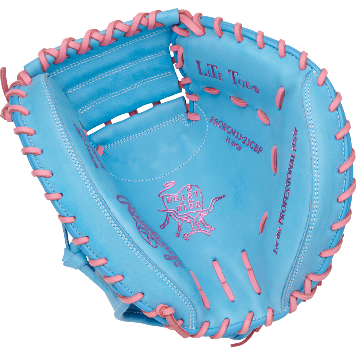 The Rawlings Heart of the Hide 33" Catcher's Mitt (PRORCM33-23CBP) features a blue design with pink lacing and stitching, the iconic Rawlings logo, and detailed text inside the glove.