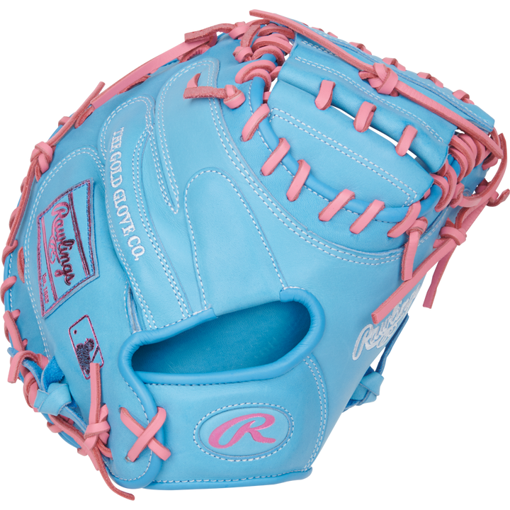 The Rawlings Heart of the Hide 33" Catcher's Mitt (PRORCM33-23CBP) features sky blue leather with pink laces, The Gold Glove Co. logos, and detailing in white and pink embroidery.