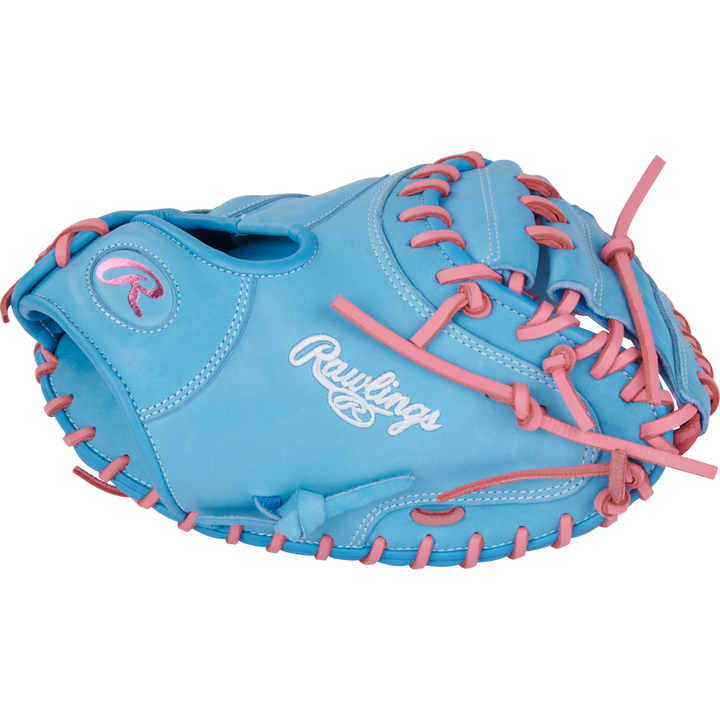 A light blue Rawlings Heart of the Hide 33" baseball catcher's mitt (PRORCM33-23CBP) with pink laces and stitching, featuring the Rawlings logo embroidered in white on the side.