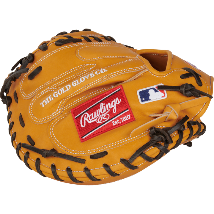The Rawlings Heart of the Hide 33" Catcher's Mitt (RPROTCM33T) features a tan design with black laces, THE GOLD GLOVE CO. stitching, a red Rawlings patch, and a white MLB logo patch on the outside.