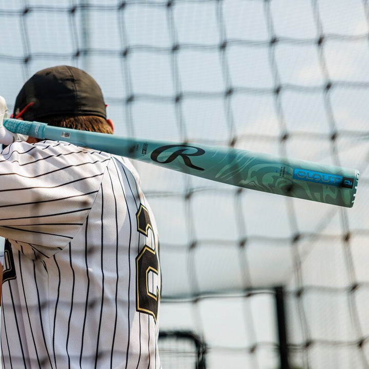 A man holding a 2025 Rawlings Clout AI (-3) BBCOR Baseball Bat: RBB5C3 (USED), an advanced BBCOR bat engineered by Rawlings using artificial intelligence.