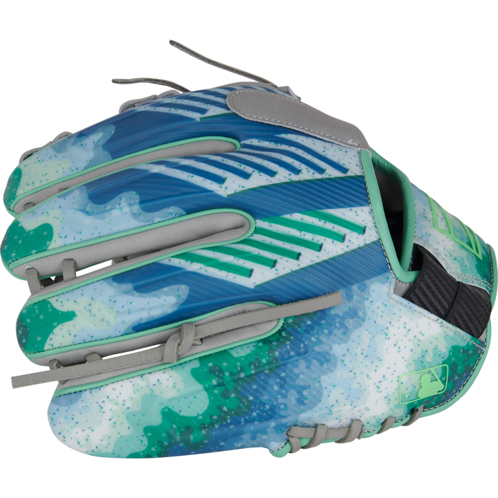 The Rawlings REV1X 11.5" Francisco Lindor GM Baseball Glove (RREVFL12G) sports blue, green, and turquoise abstract patterns, gray laces, a speckled modern design, and a small MLB logo near the wrist.