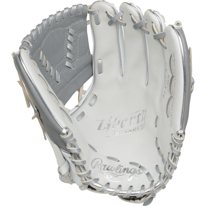 The Rawlings Liberty Advanced 12" Fastpitch Softball Glove (RRLA120-31WSS) features a white and silver design, grey lacing, "Liberty Advanced" on the palm, detailed stitching, and a webbed pocket—ideal for pitcher/infield positions.