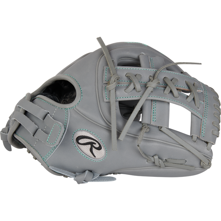 The Rawlings Liberty Advanced 11.75" Fastpitch Softball Glove (RRLA715-32G) is a gray infield glove with teal stitching and laces, made from full-grain leather. It features an open web design and the iconic Rawlings logo on the side.