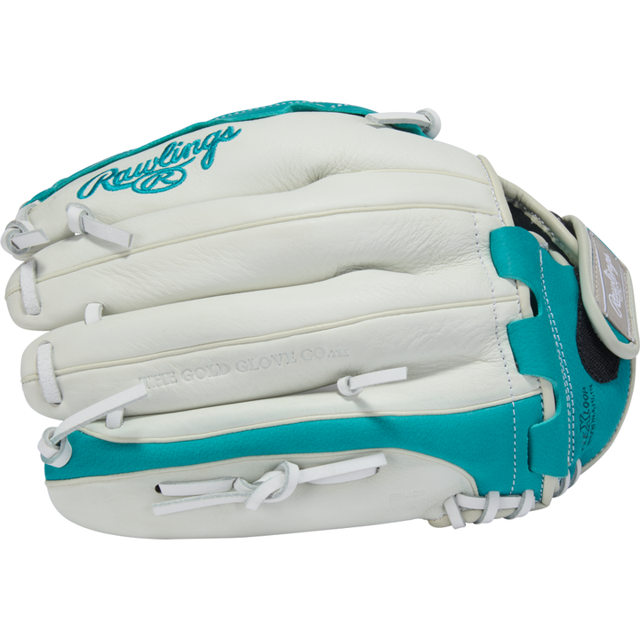 A white and teal Rawlings Shut Out 12.5" Fastpitch Glove (RSO125W) features visible stitching, laces, the Rawlings logo, and "The Gold Glove Co." embossed on the leather.