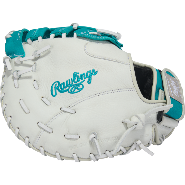 A white Rawlings Shut Out 12" Fastpitch First Base Mitt (RSOFBM12W) with teal accents and stitching, featuring the Rawlings logo embroidered in teal on the back.