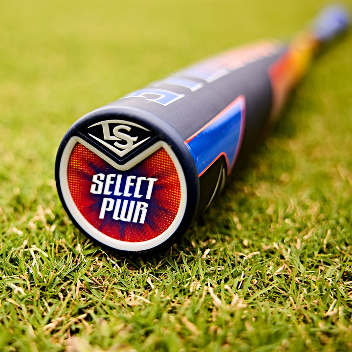 Close-up of the 2025 Louisville Slugger Select PWR (-3) BBCOR Baseball Bat (WBL2967010) resting on green grass, highlighting the EXD Premium Alloy Barrel, Select PWR end cap, and Louisville Slugger logo with a blurred background.
