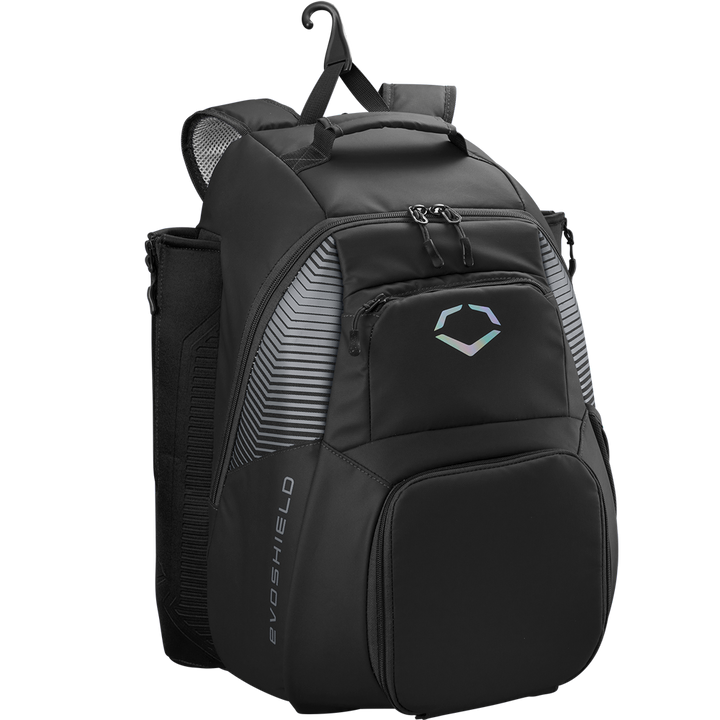 The EvoShield Tone Set Backpack (WB57304) is a black, water-resistant gear bag with multiple zippered compartments, padded shoulder straps, mesh side pockets, bat sleeves, a top hanging hook, and a white EvoShield logo.