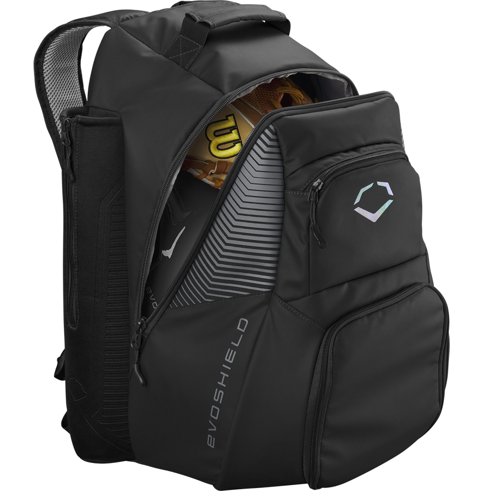 The EvoShield Tone Set Backpack (WB57304) is a black, water-resistant baseball gear bag with multiple compartments, bat sleeves, and a subtle EvoShield logo on the front pocket. The partially unzipped bag reveals a glove and bat inside.