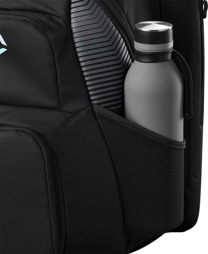 A close-up of the EvoShield Tone Set Backpack (WB57304) by EvoShield shows its water-resistant side pocket holding a gray water bottle, with a striped item, possibly a laptop or tablet, visible beside it.