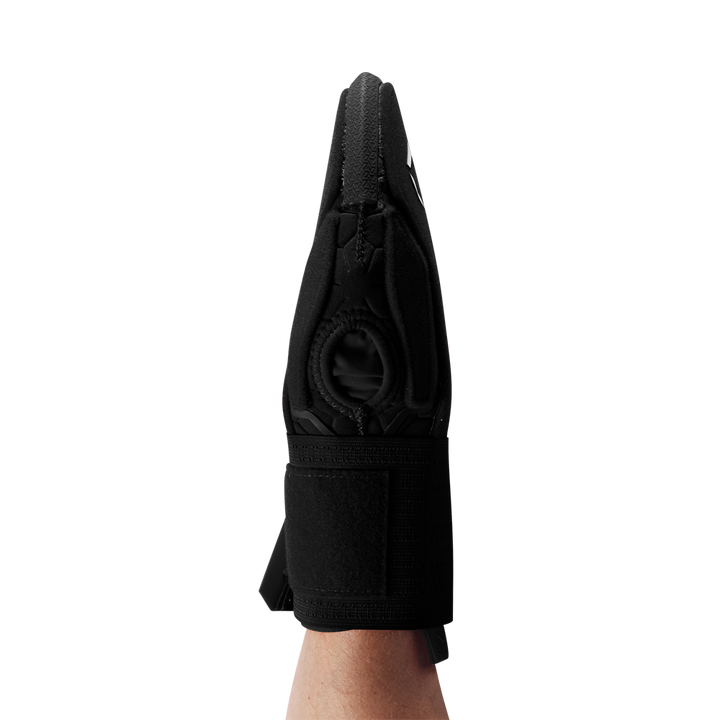 A personโs forearm is shown from the side against a plain white background, wearing the EvoShield Sliding Mitt 2.0: WB57537 by EvoShield, a black sliding mitt with a thumb hole designed for added hand protection.