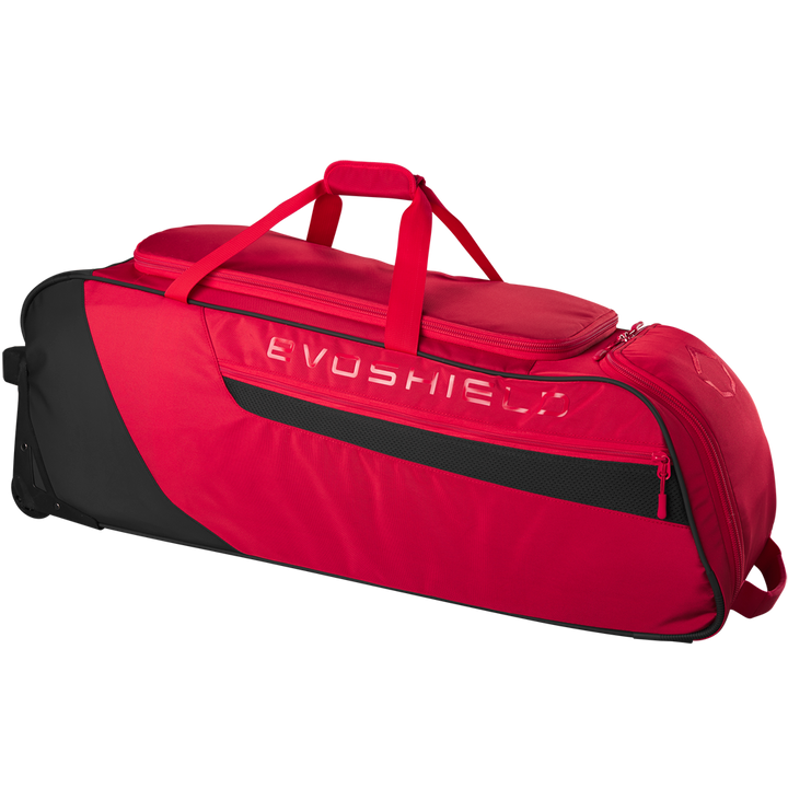 The EvoShield Takeover Wheeled Bag (WB57572) is a spacious red and black gear bag featuring a top handle, side mesh pocket, zippered compartments, and bat sleeves for easy baseball equipment transport.